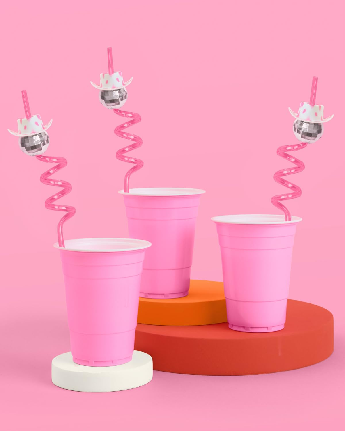 xo Fetti hot pink disco ball straw enhances photos with shiny party accents.