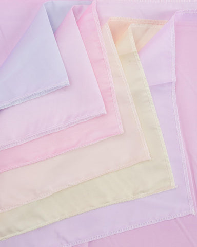 xo, Fetti pastel-gradient tablecloth shown with machine-washable care label