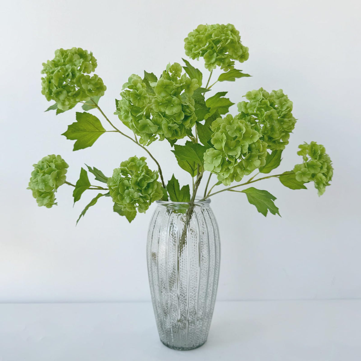 YalzoneMet Snowball Viburnum Hydrangea stem arrangement adds elegant vertical interest.