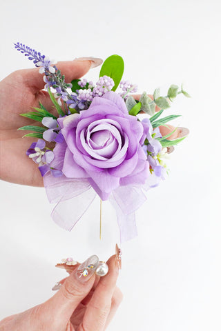 Yelinart boutonniere with pearl brooch adds secure, elegant detail for grooms