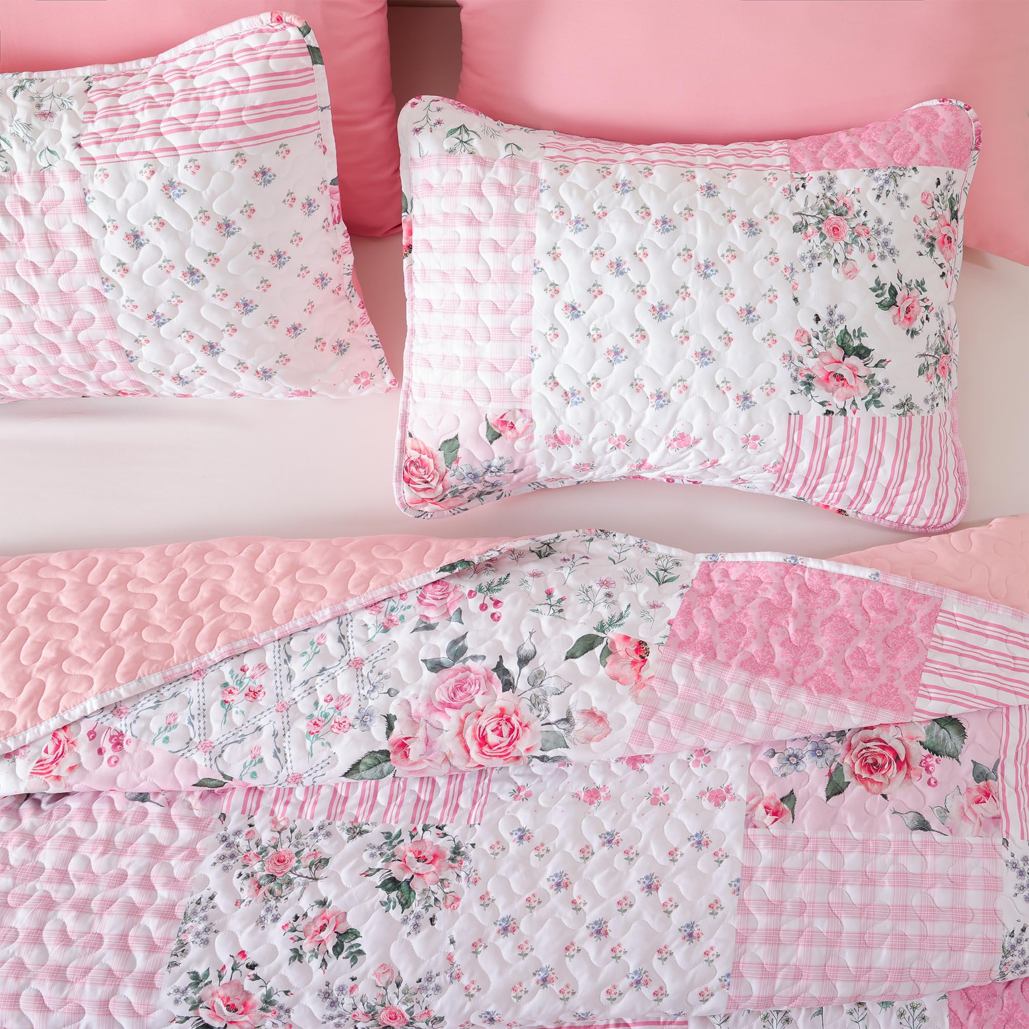 Queen bed styled with YIKUSH quilt, warm floral pattern and inviting drape.