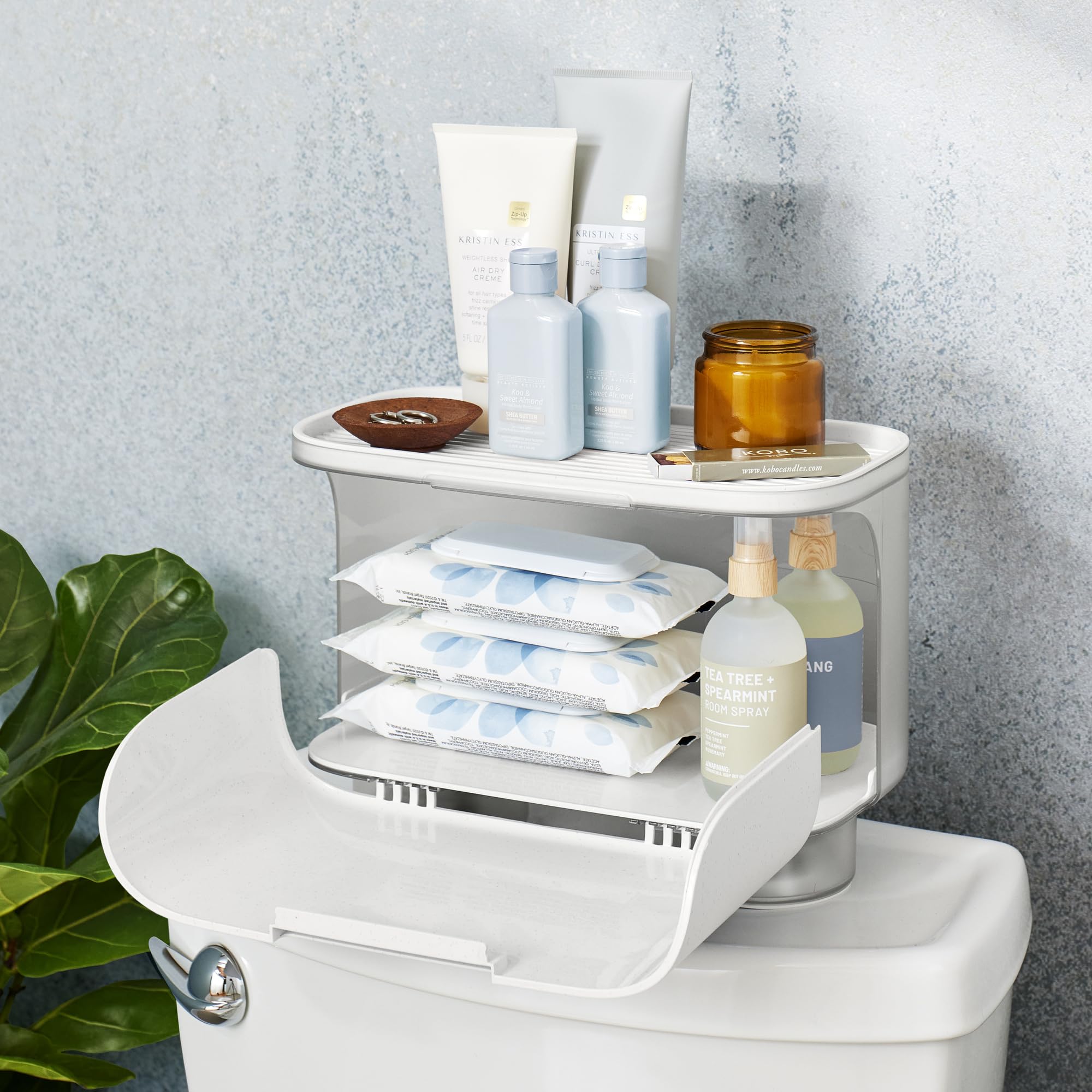 Hidden compartment fits two mega toilet paper rolls for private storage.