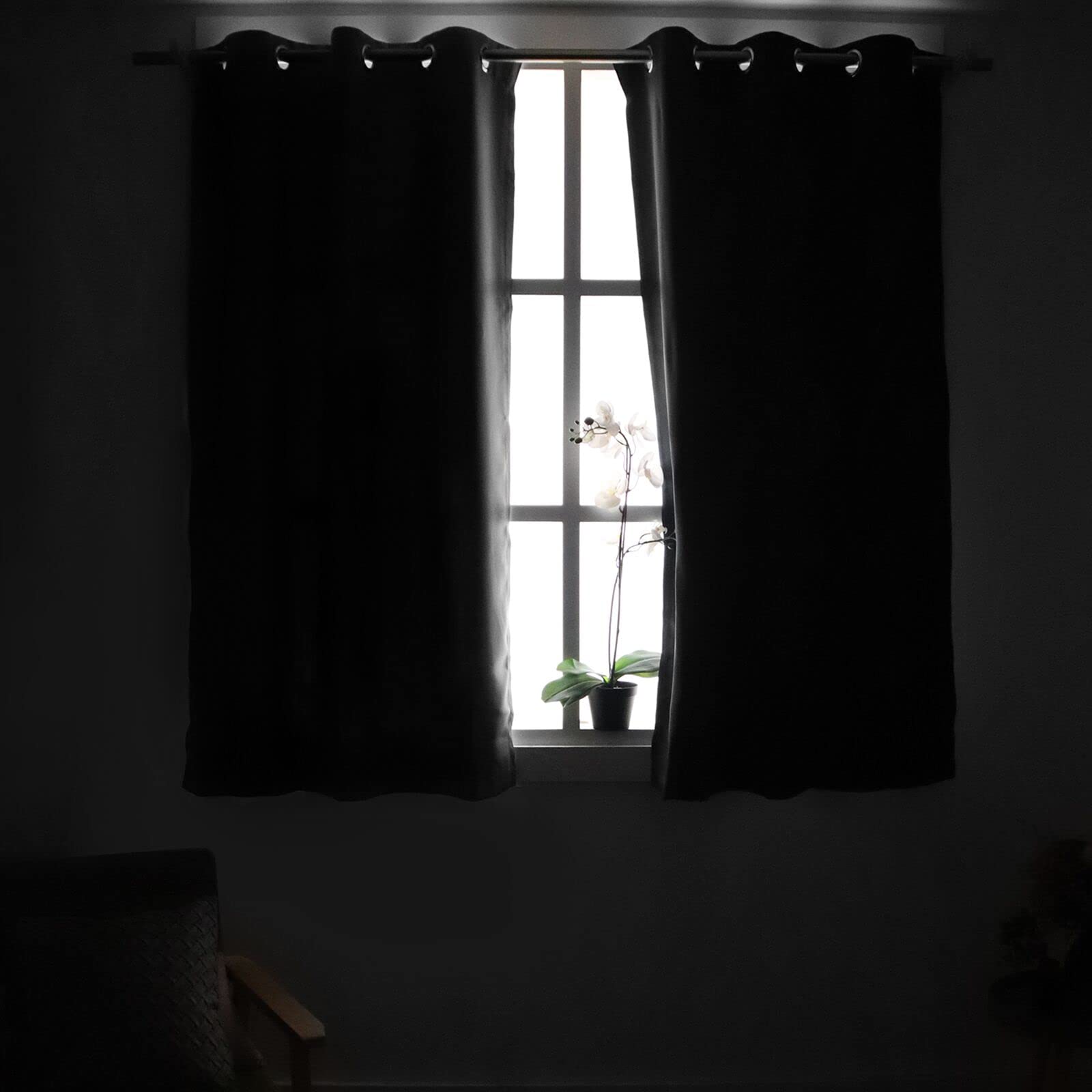 YoungsTex brown blackout curtains with silver grommets enable easy sliding.