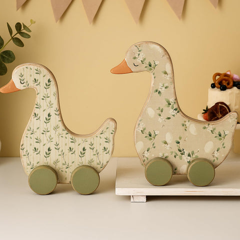 Yousoontic Silly Goose centerpiece with green foliage enhances 1st birthday decor.