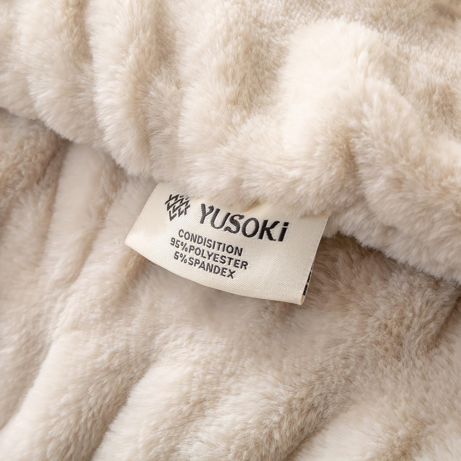YUSOKI blanket beside fireplace radiates luxury and warmth.