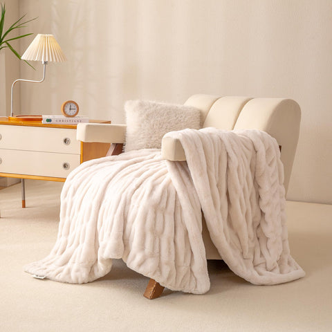 YUSOKI throw draped over bed creates inviting spa-like warmth in a modern bedroom