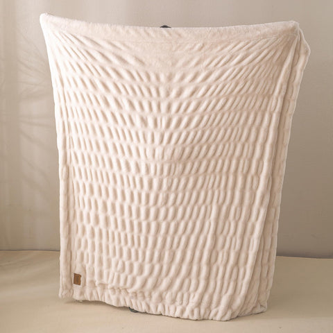 YUSOKI travel-ready blanket folds neatly in a suitcase for cozy stays
