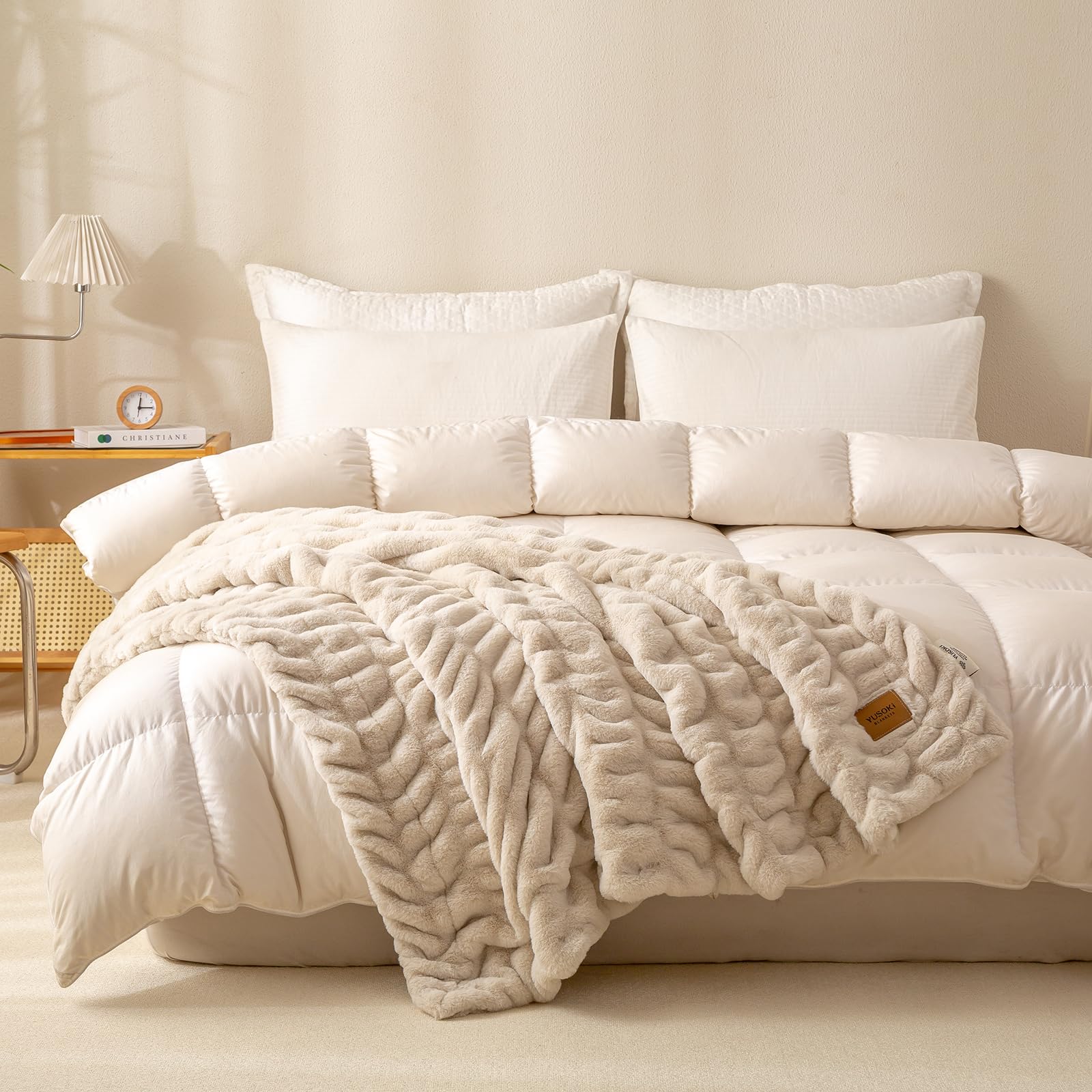 YUSOKI plush throw folded on sofa emphasizes stretchable comfort.