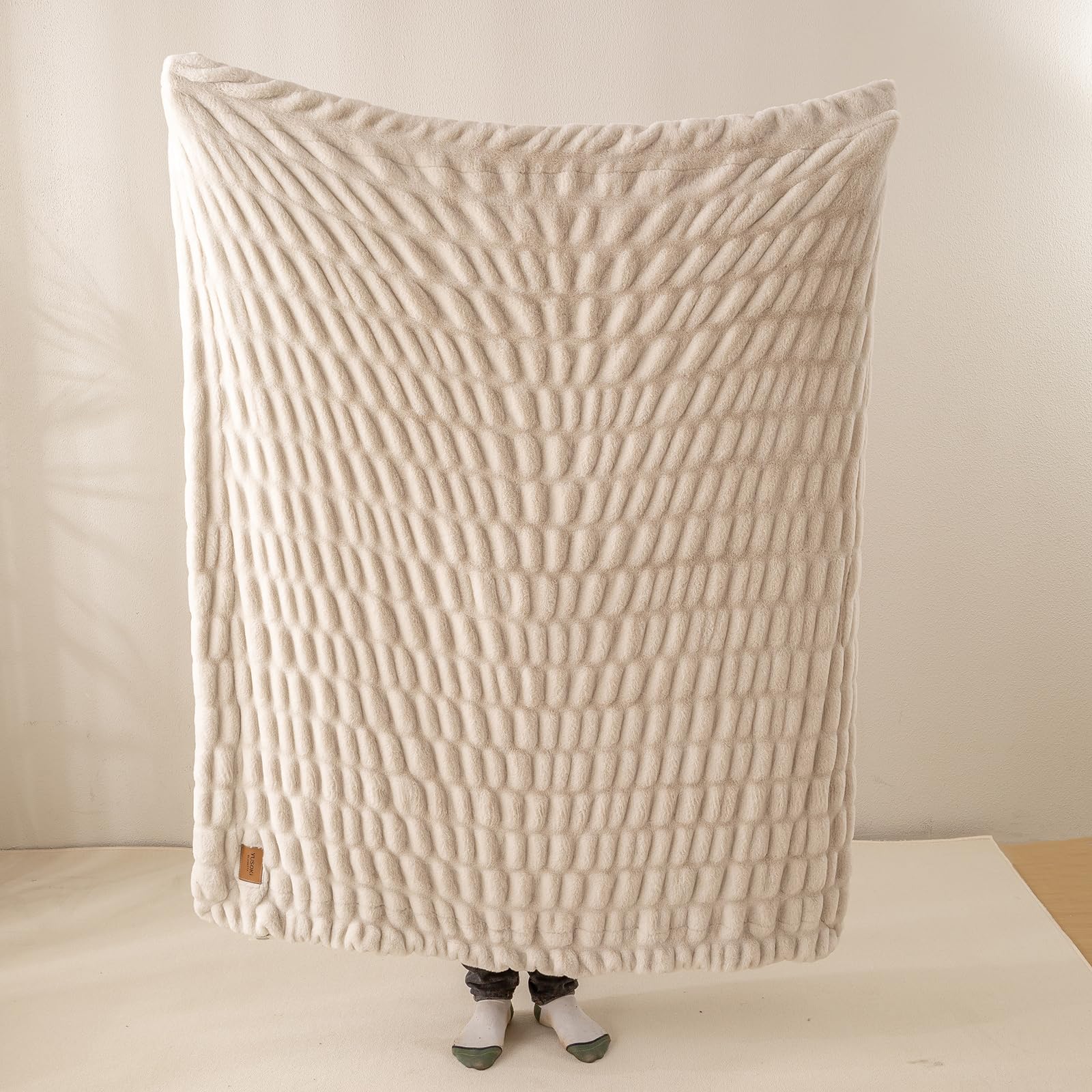 YUSOKI plush throw ready for travel use in a cozy RV setup.