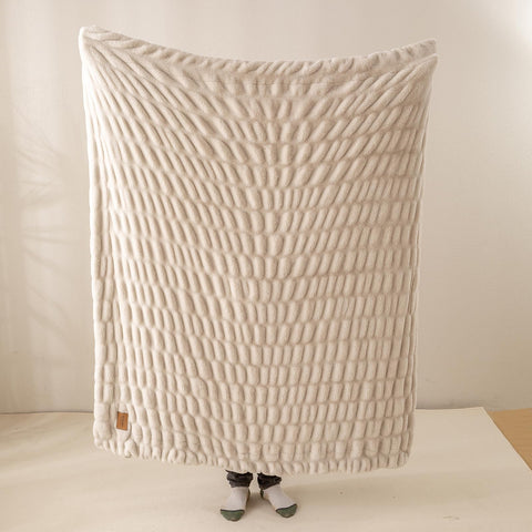 YUSOKI plush throw ready for travel use in a cozy RV setup.