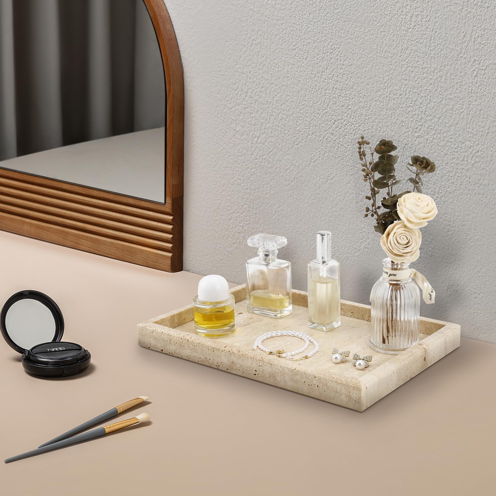 Zilukar travertine tray on bedside table for rings and cosmetics.